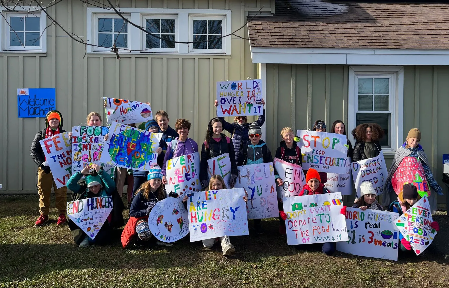 Students carrying signs for the Western Mass Food Bank